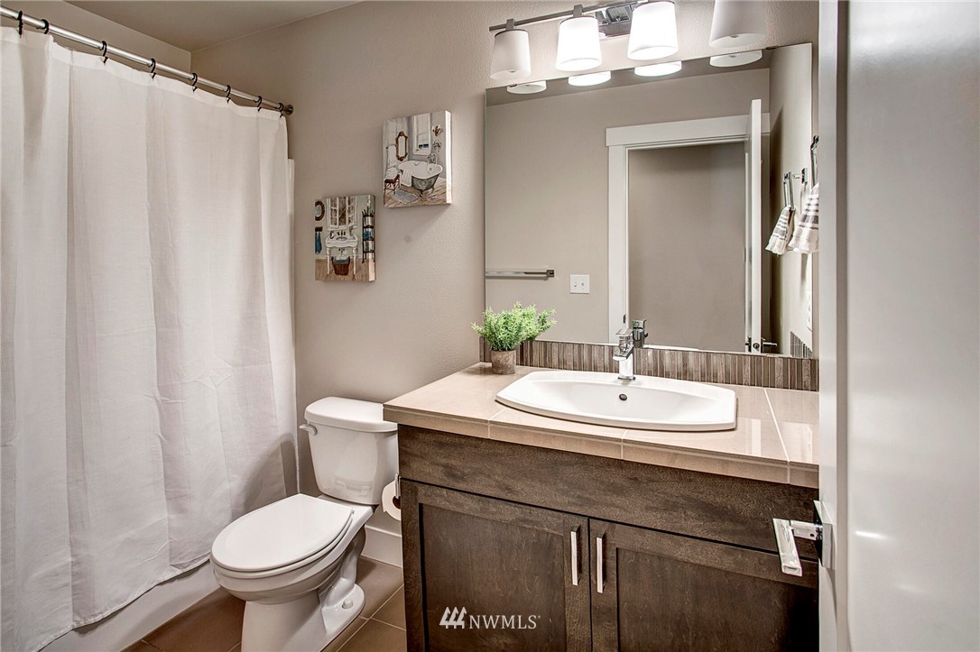 22326 9th Drive Southeast Bothell, WA 98021 - Photo 27 of 40 a bathroom with a sink toilet and a mirror