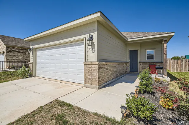 a view of backyard of house and wooden deck