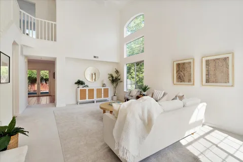 a living room with furniture a window and a table