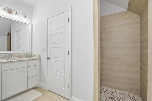 a bathroom with a shower and a sink