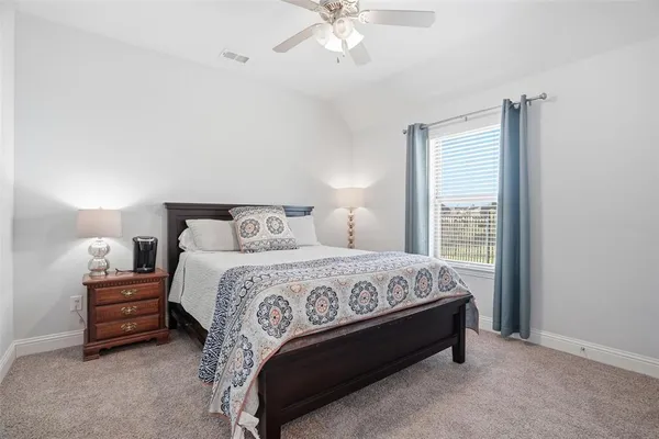 a bed sitting in a bedroom next to a window