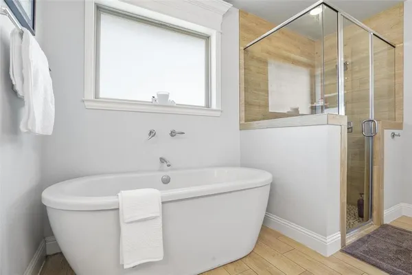 a white bath tub sitting next to a white sink