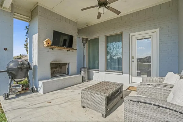 a living room with furniture a flat screen tv and a fireplace