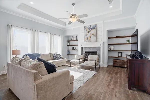 a living room with furniture fireplace and flat screen tv
