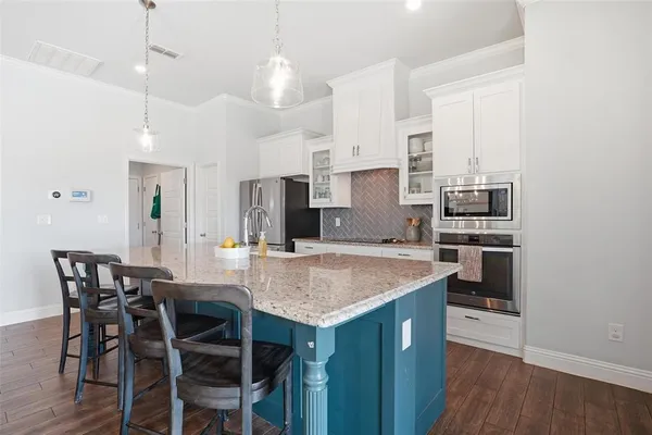 a kitchen with a table and chairs in it