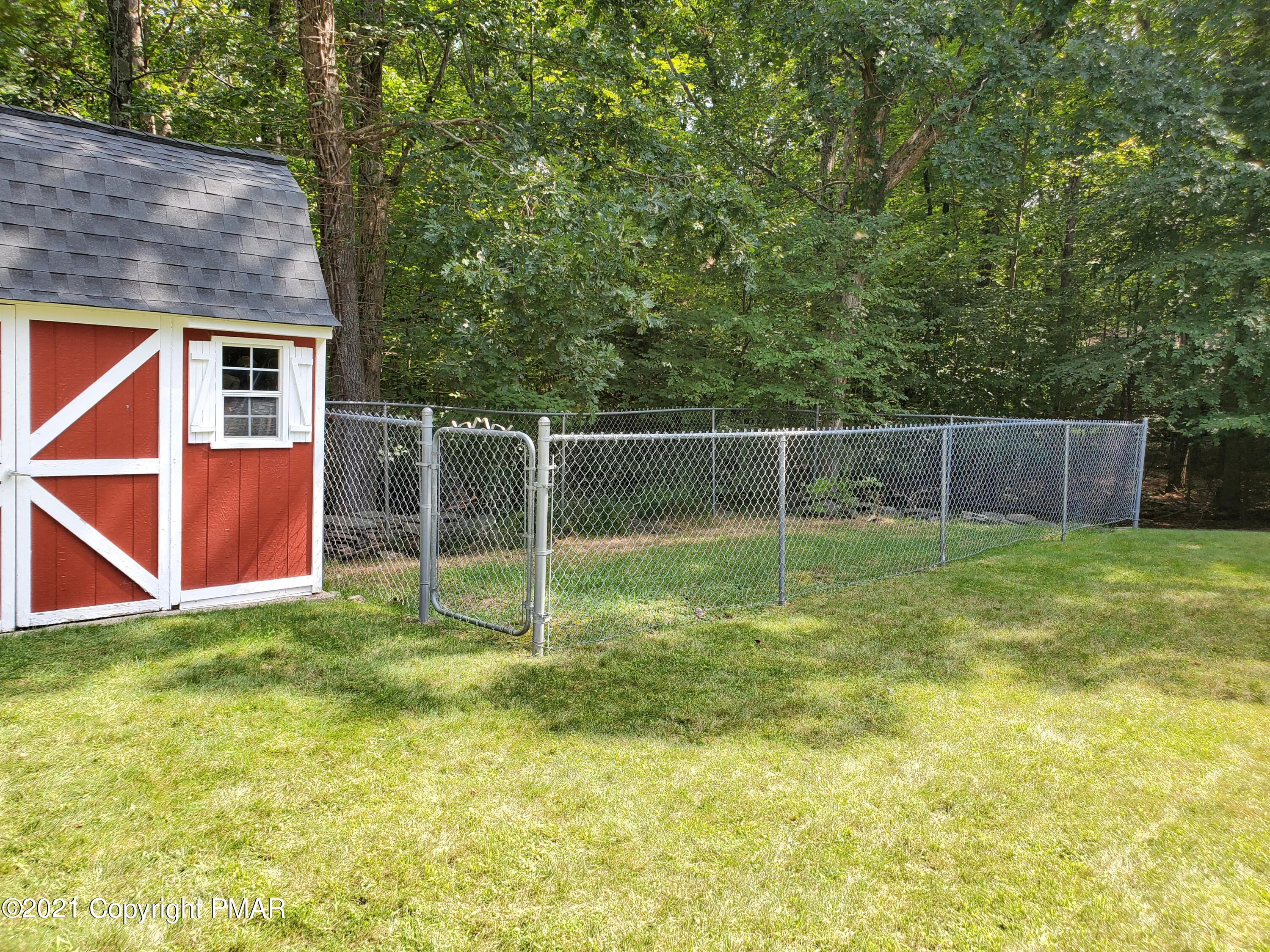 284 Powder Horn Road Henryville, PA 18332 - Photo 37 of 42 a backyard of house with swing and slide