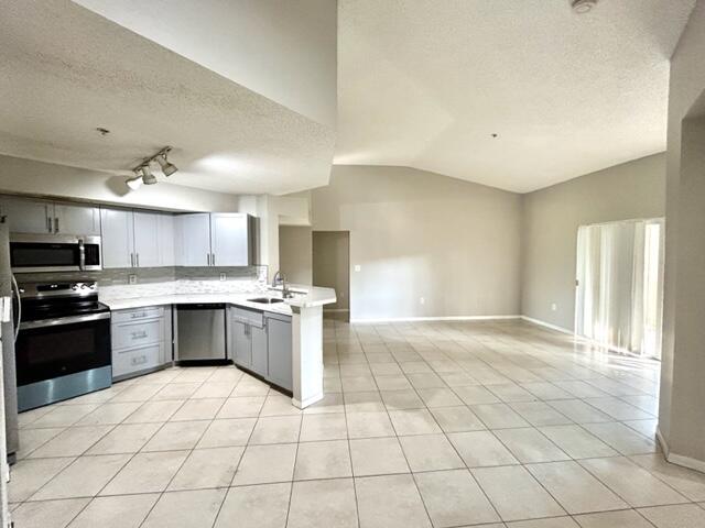 741 North Pine Island Road, Unit 303 Plantation, FL 33324 - Photo 4 of 32 a large kitchen with a stove a sink dishwasher and a refrigerator