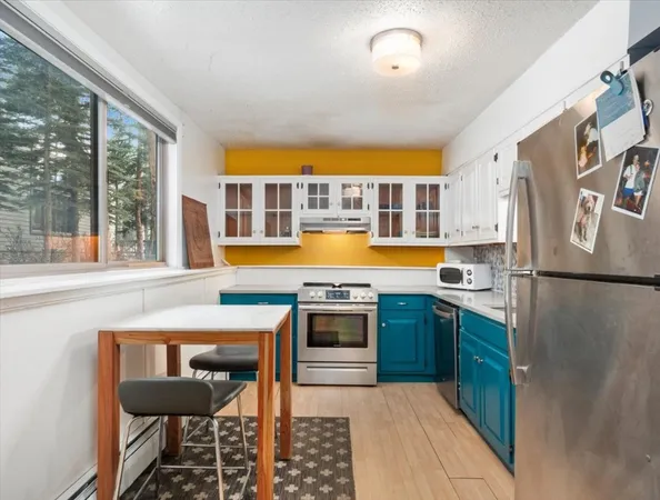 a kitchen with stainless steel appliances granite countertop a stove and a refrigerator