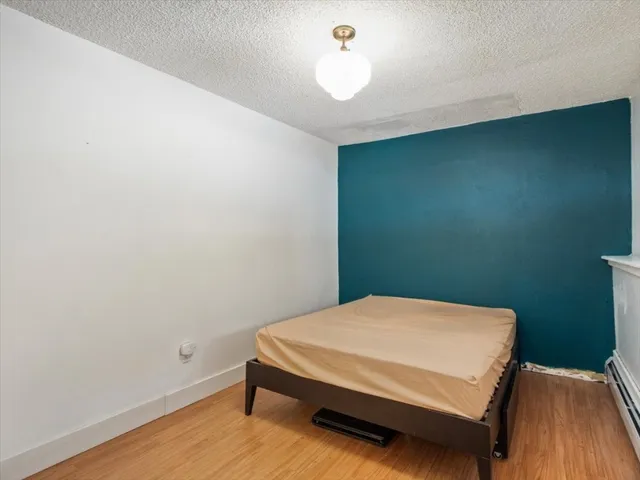 a bed sitting in a bedroom next to a wooden cabinet
