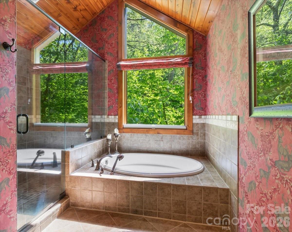 121 Ivy Ridge Road Burnsville, NC 28714 - Photo 22 of 48 a bath tub sitting in a bathroom next to a window