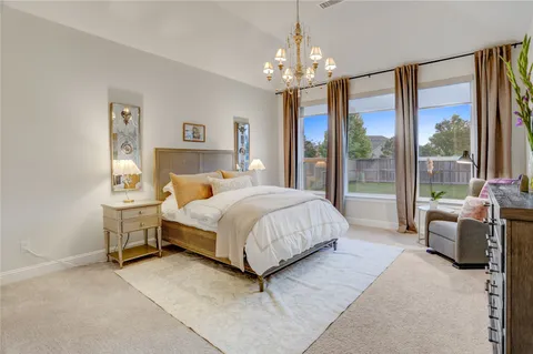 a large white bathroom with a double vanity sink a mirror a shower and a bathtub