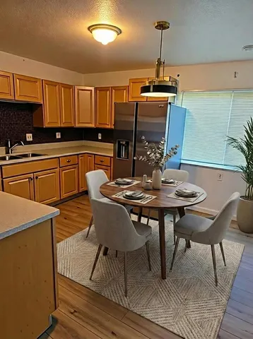 a kitchen with a table chairs sink and cabinets