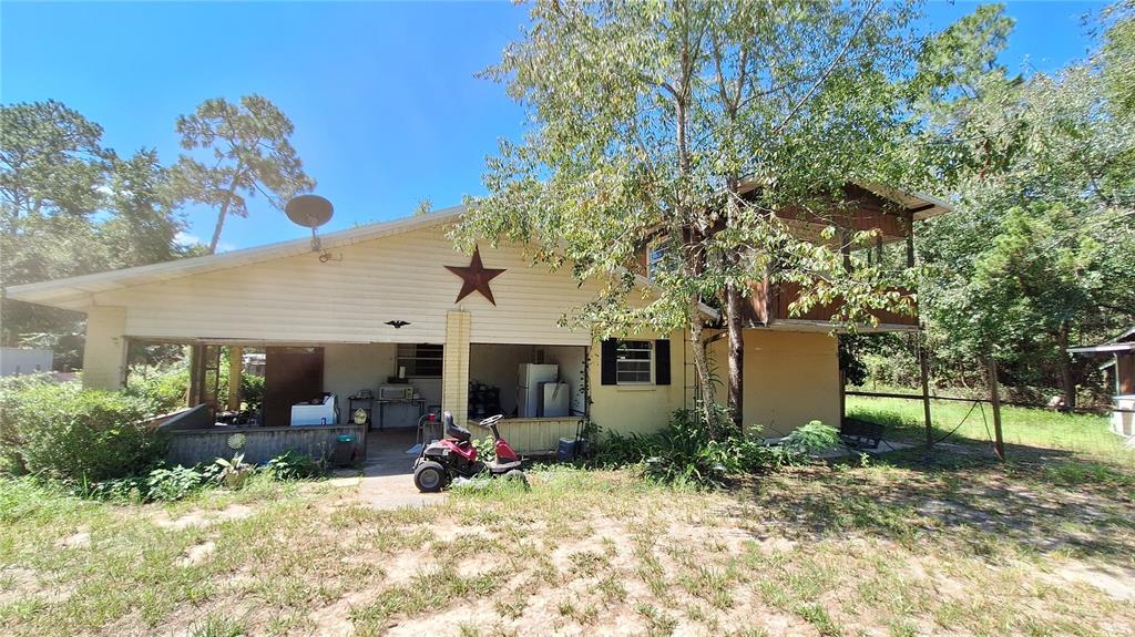a view of a patio with table and chairs and potted plants