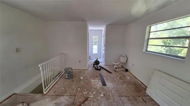 a room with exposed radiator and windows