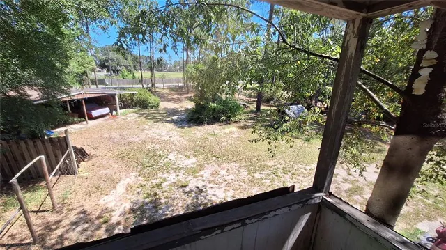 a view of roof deck with wooden fence and floor