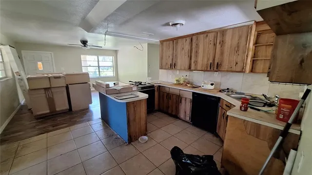a kitchen with a sink stove top oven and cabinets