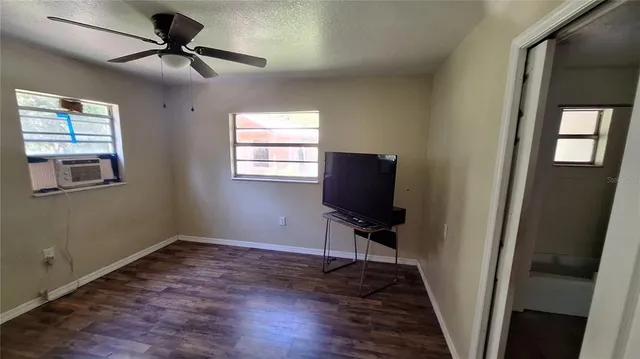 a view of room with a flat screen tv and a window