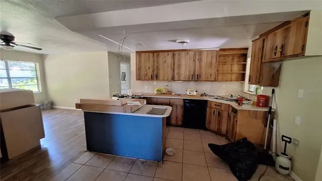 a kitchen with kitchen island granite countertop a sink counter top space and cabinets