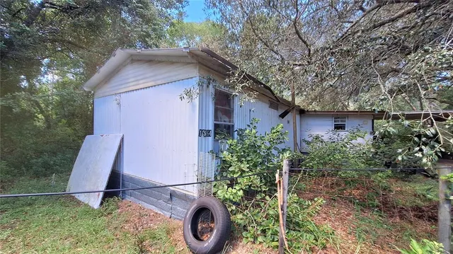 a house with lots of trees in the background