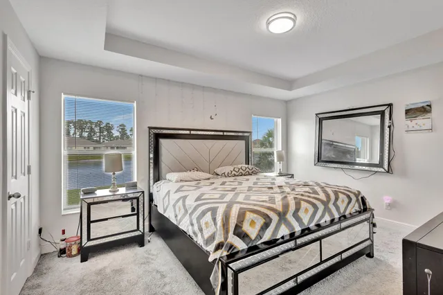 a bedroom with a bed and a night stand