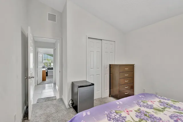 a bedroom with a bed and a dresser