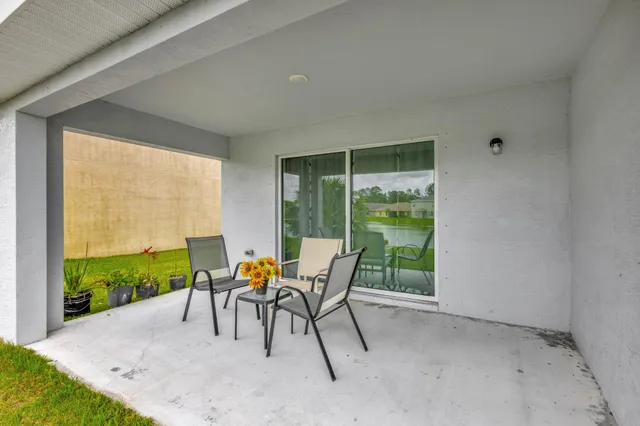 a patio with yard table and chairs