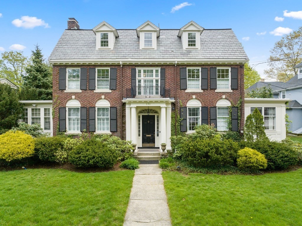 a front view of a house with garden and porch