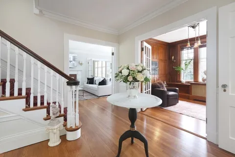 a dining room with furniture and wooden floor