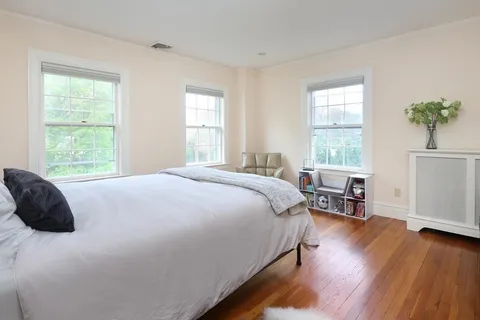 a bedroom with a bed a table and a window