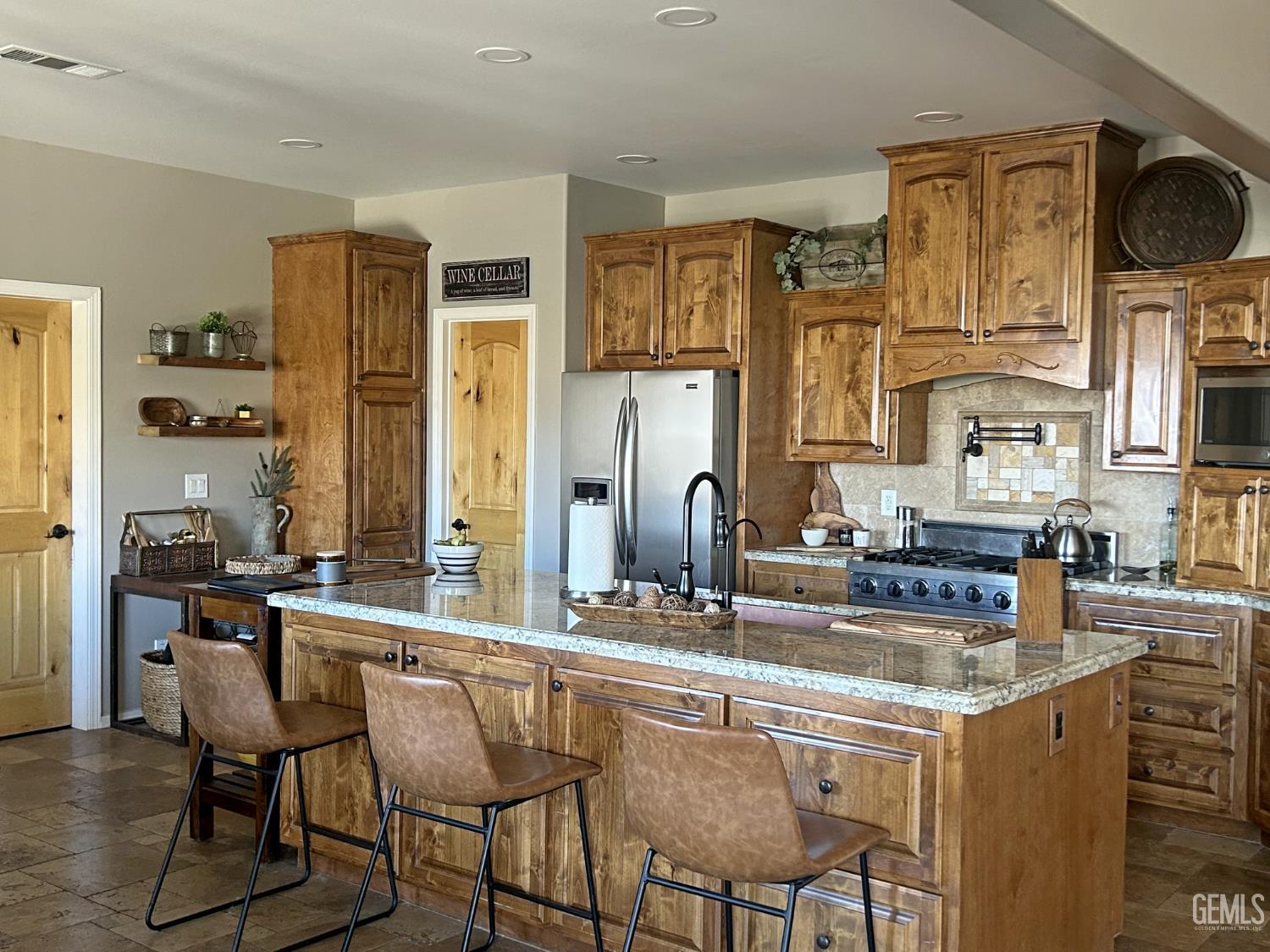 Undisclosed Address Lake Isabella, CA 93240 - Photo 11 of 40 a kitchen with stainless steel appliances kitchen island granite countertop a table chairs in it and wooden floors