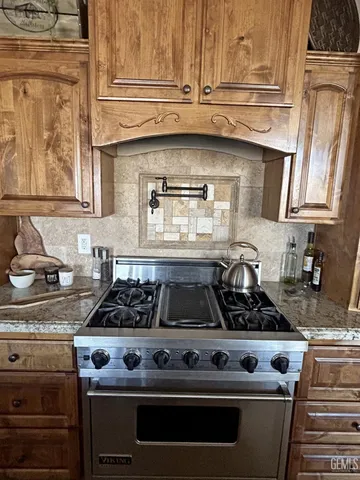 a kitchen with stainless steel appliances granite countertop a stove and a sink