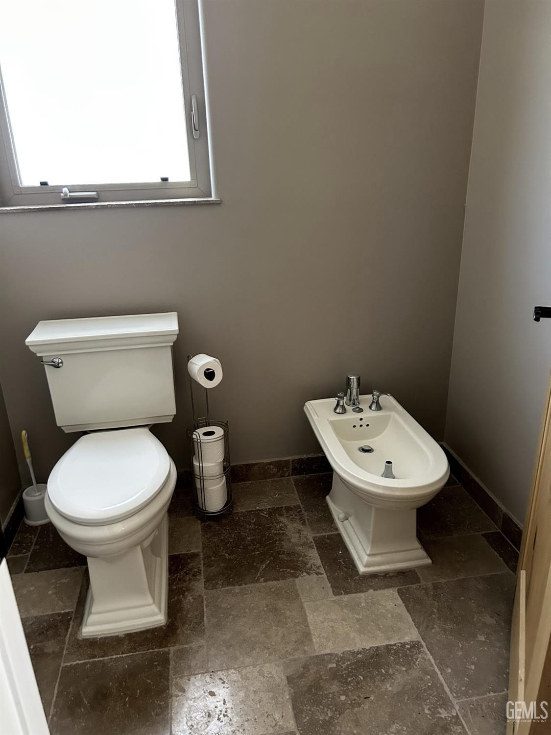 Undisclosed Address Lake Isabella, CA 93240 - Photo 26 of 40 a white toilet sitting next to a bathroom sink