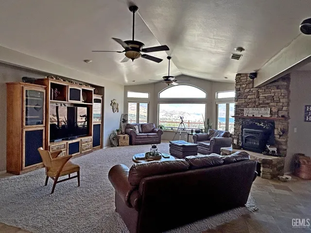 a living room with furniture a fireplace and a chandelier