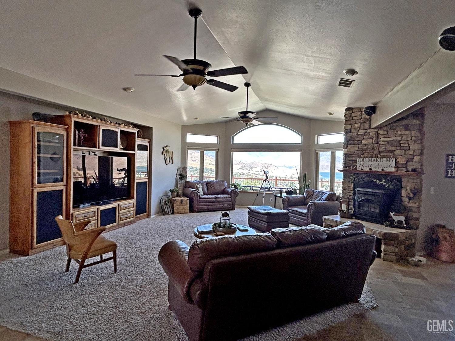 Undisclosed Address Lake Isabella, CA 93240 - Photo 6 of 40 a living room with furniture a fireplace and a chandelier