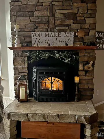 a view of a fireplace with wooden wall