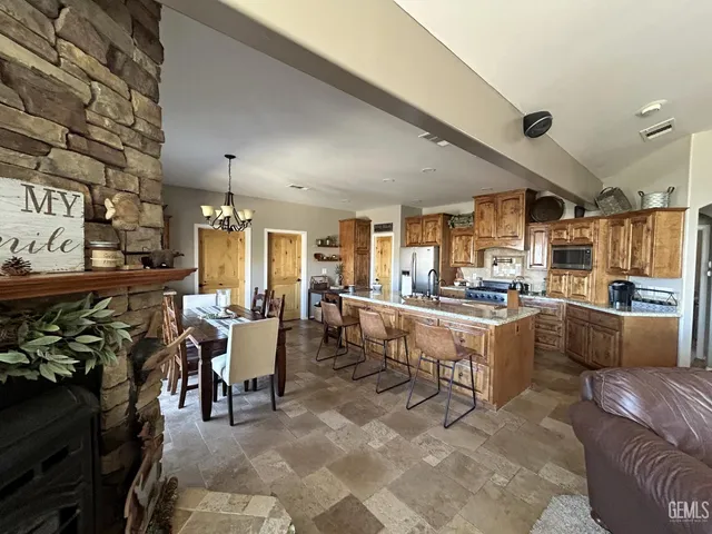 a large room with lots of tables a flat screen tv and couches