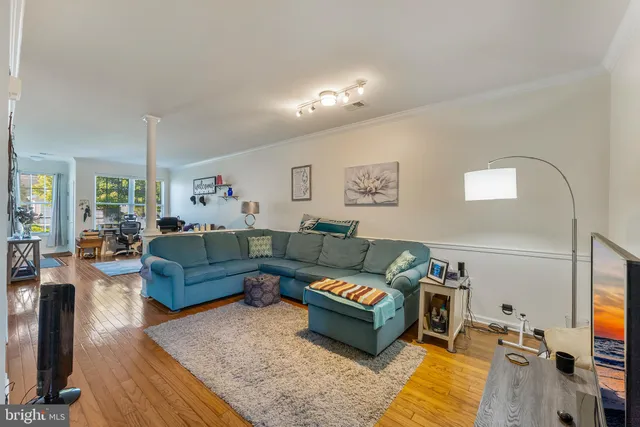a living room with furniture a rug and a flat screen tv