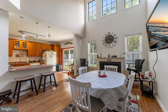 a dining room with furniture a window and wooden floor
