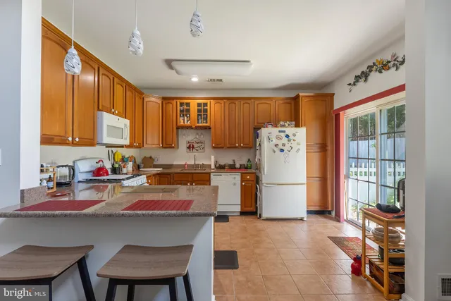 a kitchen with a refrigerator a stove top oven a sink and dishwasher