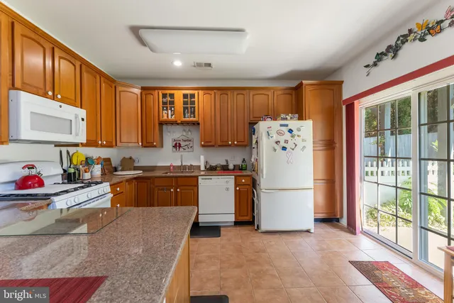 a kitchen with a refrigerator and a sink
