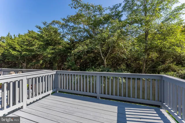 a view of balcony with wooden floor and fence