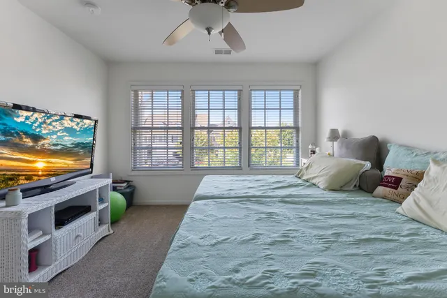 a bed sitting in a bedroom next to a window