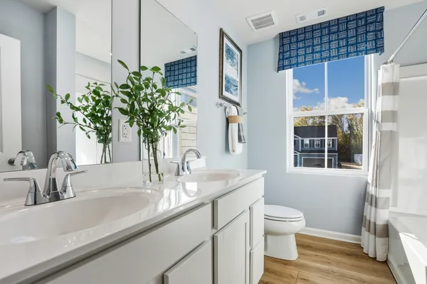 a bathroom with a sink a toilet and a mirror