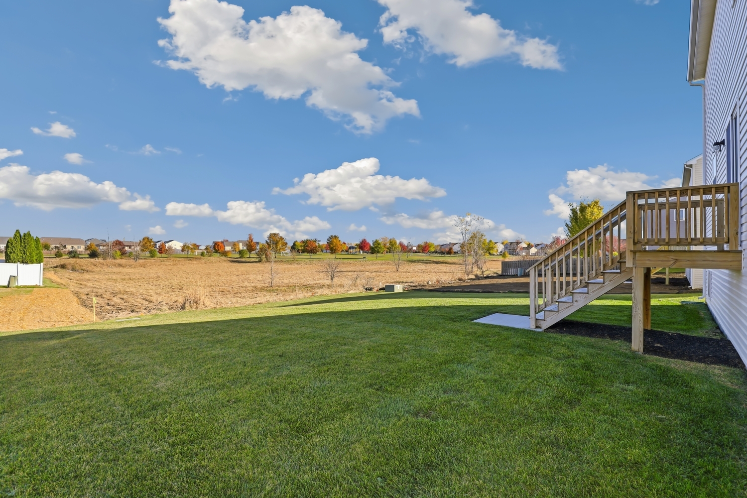 1725 Sunglow Lane DeKalb, IL 60115 - Photo 18 of 20 a view of a house with a big yard and potted plants