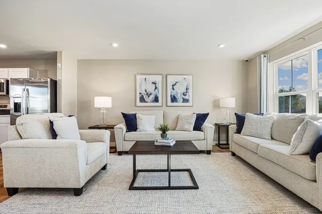 a living room with furniture and a large window