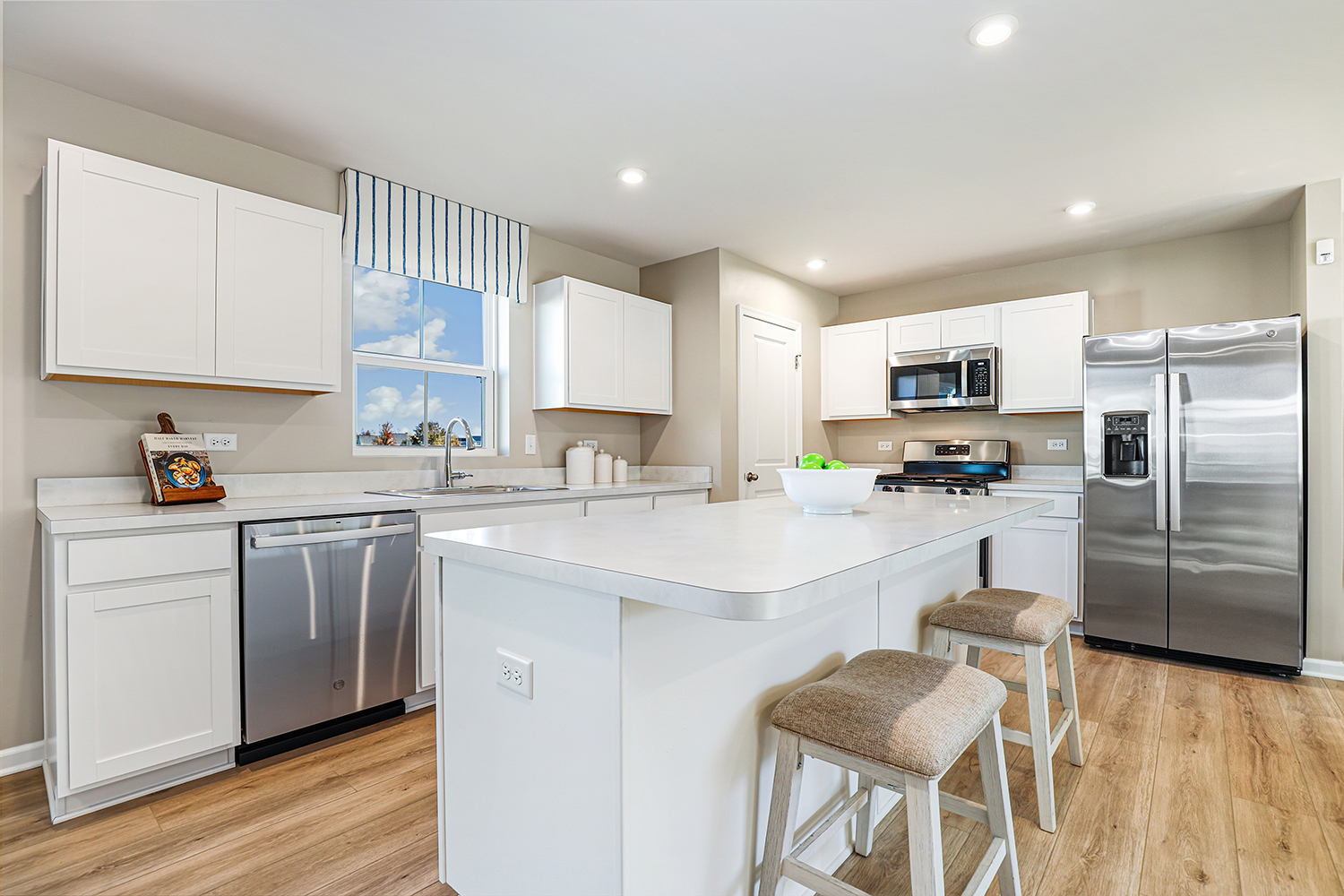1725 Sunglow Lane DeKalb, IL 60115 - Photo 5 of 20 a kitchen with white cabinets and stainless steel appliances