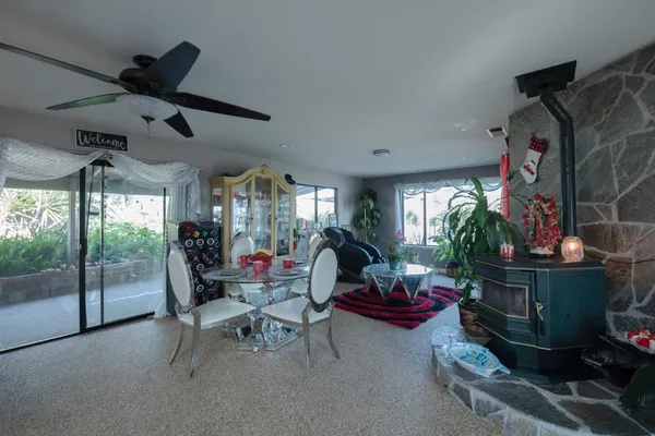 a view of a patio with table and chairs potted plants with wooden floor