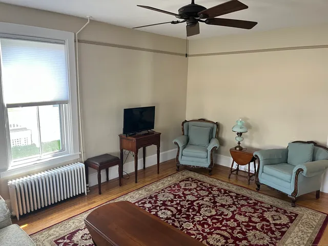 a living room with furniture rug and window