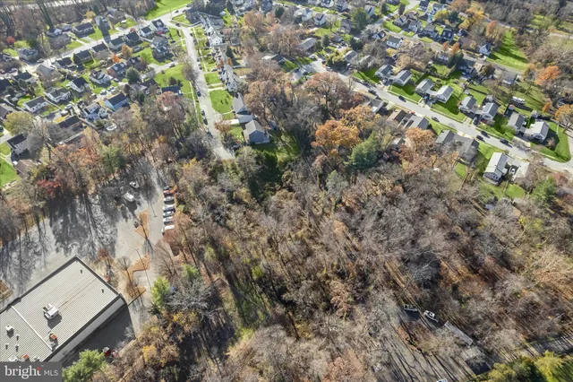 an aerial view of house with yard and mountain view in back