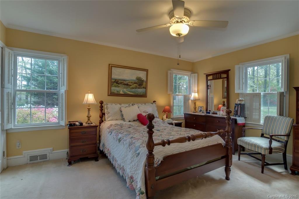 194 Harris Street Rutherfordton, NC 28139 - Photo 12 of 24 a bedroom with a bed and a chandelier next to a window